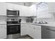 Kitchen featuring stainless steel appliances, white cabinets, and modern fixtures, offering a clean aesthetic at 5801 Oyster Catcher Dr. # 332, North Myrtle Beach, SC 29582