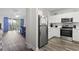Modern kitchen with white cabinets, stainless steel appliances, and an open view to living area and deck at 5801 Oyster Catcher Dr. # 332, North Myrtle Beach, SC 29582