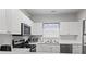 Modern kitchen featuring stainless steel appliances, white cabinets, and a view of the sink and dishwasher at 5801 Oyster Catcher Dr. # 332, North Myrtle Beach, SC 29582