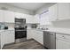 Bright kitchen with white cabinets, stainless steel appliances including a dishwasher, and modern finishes at 5801 Oyster Catcher Dr. # 332, North Myrtle Beach, SC 29582