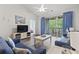 Cozy living room featuring a sliding glass door leading to a covered balcony with outdoor seating at 5801 Oyster Catcher Dr. # 332, North Myrtle Beach, SC 29582