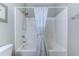 Bathroom featuring a shower-tub combination with white tile surround at 601 N Hillside Dr. # 4434, North Myrtle Beach, SC 29582