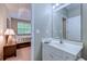 Bathroom with white vanity and view into a bedroom with natural light at 601 N Hillside Dr. # 4434, North Myrtle Beach, SC 29582