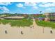 Aerial view of a beach path leading to the ocean with shops and a water tower in the background at 601 N Hillside Dr. # 4434, North Myrtle Beach, SC 29582