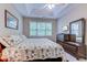 Bright bedroom with tray ceiling, fan, and dresser with mirror and television at 601 N Hillside Dr. # 4434, North Myrtle Beach, SC 29582