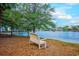 Inviting bench overlooks tranquil lake, offering serene views of lakeside living at 601 N Hillside Dr. # 4434, North Myrtle Beach, SC 29582