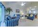Comfortable living room with a ceiling fan, a decorative plant, and screened balcony access at 601 N Hillside Dr. # 4434, North Myrtle Beach, SC 29582