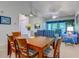 Bright living room open to dining area with ceiling fan and doors to the screened balcony at 601 N Hillside Dr. # 4434, North Myrtle Beach, SC 29582
