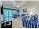 Inviting living room with vaulted ceilings, neutral carpet, and access to a screened porch at 601 N Hillside Dr. # 4434, North Myrtle Beach, SC 29582