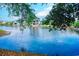 Scenic view of a pond with waterfront homes reflected in the calm water at 601 N Hillside Dr. # 4434, North Myrtle Beach, SC 29582