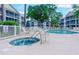 Community pool area featuring a hot tub, swimming pool, and lounge chairs for residents at 601 N Hillside Dr. # 4434, North Myrtle Beach, SC 29582