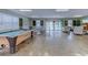 Recreation room with a pool table, ping pong table, and lounge area overlooking the outdoor pool at 601 N Hillside Dr. # 4434, North Myrtle Beach, SC 29582