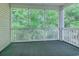 Relaxing screened porch with green carpet and scenic views of the surrounding trees at 601 N Hillside Dr. # 4434, North Myrtle Beach, SC 29582