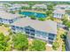 An aerial view capturing condos overlooking a serene pond with a fountain feature, lush greenery, and a well-manicured community at 6203 Catalina Dr. # 1333, North Myrtle Beach, SC 29582