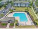 Aerial view of a modern community pool with ample seating, umbrellas, and manicured landscaping at 6203 Catalina Dr. # 1333, North Myrtle Beach, SC 29582