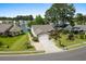Aerial view of a residential property with well-manicured lawn, and access to a community lake at 675 Vermillion Dr., Little River, SC 29566