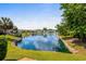 Picturesque backyard with a tranquil pond featuring a fountain and beautifully landscaped shoreline at 675 Vermillion Dr., Little River, SC 29566