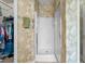 Bathroom showcases a glass-enclosed shower, towel rack, patterned wallpaper, and easy access to the closet at 675 Vermillion Dr., Little River, SC 29566