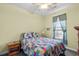 Bedroom boasts a ceiling fan, window with curtains, a bed, and side tables at 675 Vermillion Dr., Little River, SC 29566