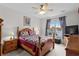 Cozy bedroom with lake views, ceiling fan, and wood furniture with colorful quilt at 675 Vermillion Dr., Little River, SC 29566