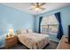 Comfortable bedroom featuring a window with blue curtains, ceiling fan, and a double bed at 675 Vermillion Dr., Little River, SC 29566