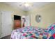 Bedroom features a ceiling fan, mirror, dresser with television, and a closet at 675 Vermillion Dr., Little River, SC 29566