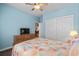 Comfortable bedroom features a bed, dresser with television, ceiling fan, and a closet at 675 Vermillion Dr., Little River, SC 29566