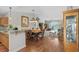 Open-concept dining area features a wooden table with seating for six and transitions into a living space with lake views at 675 Vermillion Dr., Little River, SC 29566