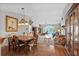 Open-concept dining area featuring a wooden table with seating for six and transitioning into a bright and open living space at 675 Vermillion Dr., Little River, SC 29566