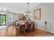 Open-concept dining area that connects to a kitchen and sitting area; a wooden table that seats six at 675 Vermillion Dr., Little River, SC 29566