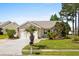 Charming single-story home featuring a well-manicured lawn, an attached two-car garage, and a cozy landscaped front yard at 675 Vermillion Dr., Little River, SC 29566