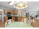 Bright kitchen featuring stainless steel appliances, granite countertops, light wood cabinets, and a breakfast bar at 675 Vermillion Dr., Little River, SC 29566