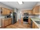 Kitchen area with stainless steel refrigerator, appliances and light wood cabinets with granite countertops at 675 Vermillion Dr., Little River, SC 29566