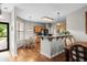 Open kitchen with wood cabinets, granite counters, stainless appliances, and an adjacent breakfast nook at 675 Vermillion Dr., Little River, SC 29566