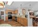 Well-lit kitchen with granite countertops, stainless steel appliances, and light wood cabinets at 675 Vermillion Dr., Little River, SC 29566