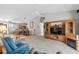 Spacious living room with plush seating, a ceiling fan, and an entertainment center, flowing into the dining and kitchen area at 675 Vermillion Dr., Little River, SC 29566