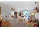 Open-concept living room leads to a bedroom and an office overlooking the lake, featuring comfortable seating and a vaulted ceiling at 675 Vermillion Dr., Little River, SC 29566