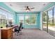 Bright office space with a ceiling fan, large windows, and a sliding door, offering ample natural light and ventilation at 675 Vermillion Dr., Little River, SC 29566
