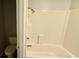 White bathroom features shower-tub combo with white subway tile and toilet on the side at 6805 Mclaurin Rd., Mullins, SC 29574