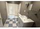 Bathroom features a shower/tub, a sink with vanity and checkered floors at 6805 Mclaurin Rd., Mullins, SC 29574
