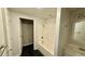 White tiled bathroom features a shower-tub combo, dark tile floor, and vanity sink at 6805 Mclaurin Rd., Mullins, SC 29574