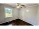 Bedroom with dark wood floors and ceiling fan, enhanced by natural light from a window at 6805 Mclaurin Rd., Mullins, SC 29574