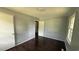 Bedroom with hardwood floors, gray walls, white doors, trim and window to provide natural light at 6805 Mclaurin Rd., Mullins, SC 29574