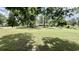 Large, grassy front yard with mature trees, offering plenty of space and shade at 6805 Mclaurin Rd., Mullins, SC 29574