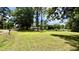 Expansive front yard with lush green grass and mature trees, providing ample space at 6805 Mclaurin Rd., Mullins, SC 29574