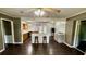 Inviting living space with wood floors, ceiling fan, and a seamless flow to the kitchen with island seating at 6805 Mclaurin Rd., Mullins, SC 29574
