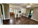 Open-concept space with wood floors and island seating that merges the living and kitchen areas seamlessly at 6805 Mclaurin Rd., Mullins, SC 29574