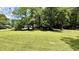 Expansive green front yard with mature trees, offering a serene and inviting setting at 6805 Mclaurin Rd., Mullins, SC 29574