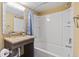 This bathroom has a granite countertop, mirror with lights, and white tiled walls at 6900 N Ocean Blvd. # 222, Myrtle Beach, SC 29572