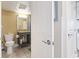 Bathroom with a toilet, granite countertop, and a mirror with lights at 6900 N Ocean Blvd. # 222, Myrtle Beach, SC 29572